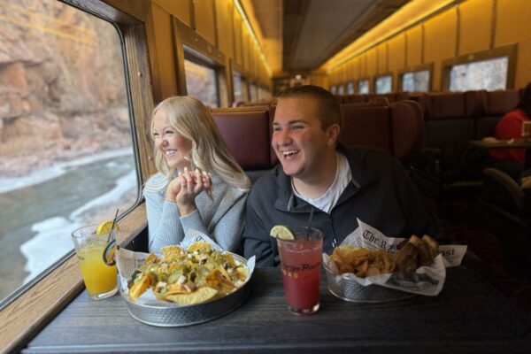 IMG_6158 People on train enjoying drinks and food, happy